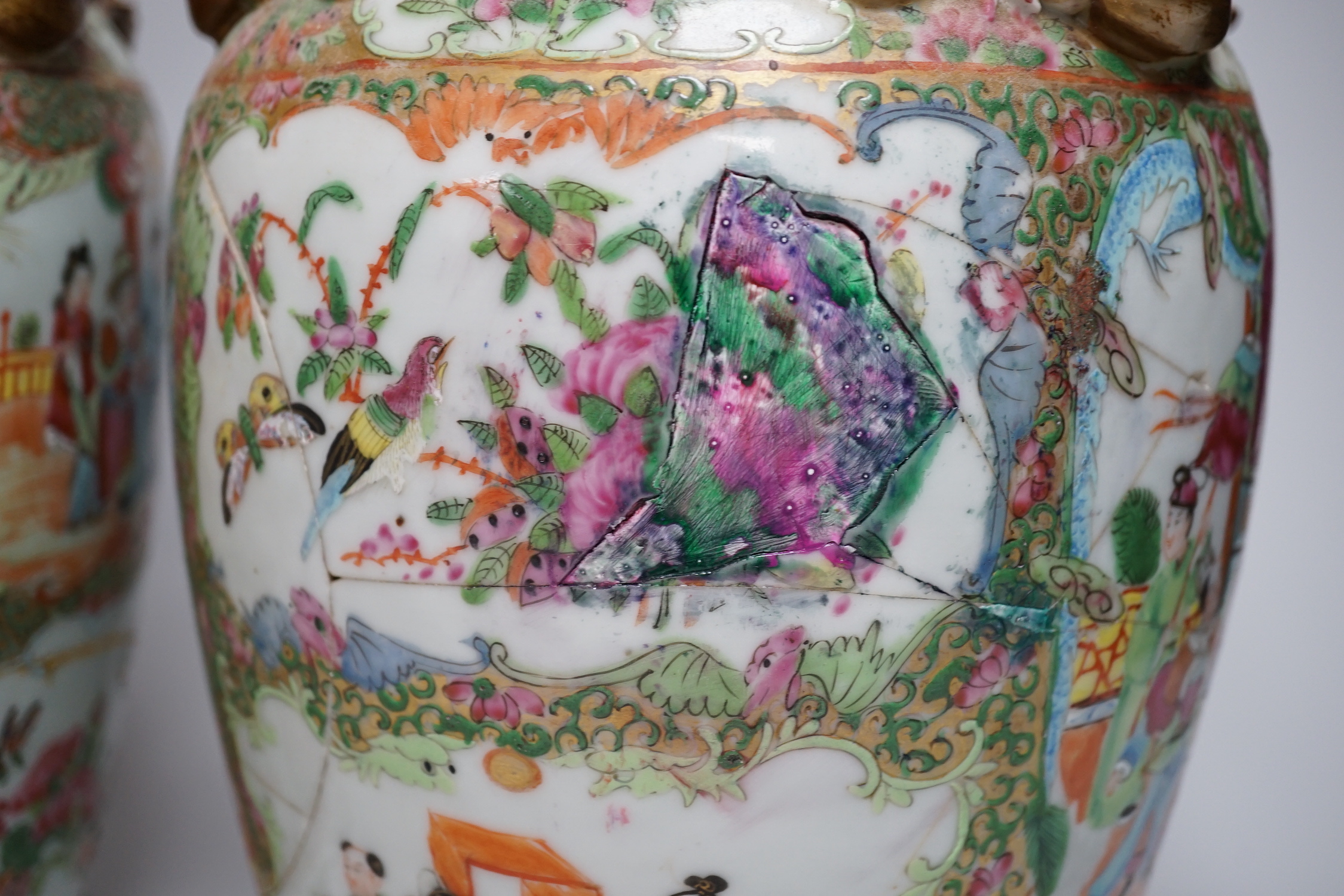 A pair of Chinese Canton decorated famille rose enamelled vases, 36cm high, an early 20th century Chinese blue and white baluster vase, 25cm (a.f.), a 19th century Chinese blue and white gu shaped vase, 37.5cm (a.f.), a